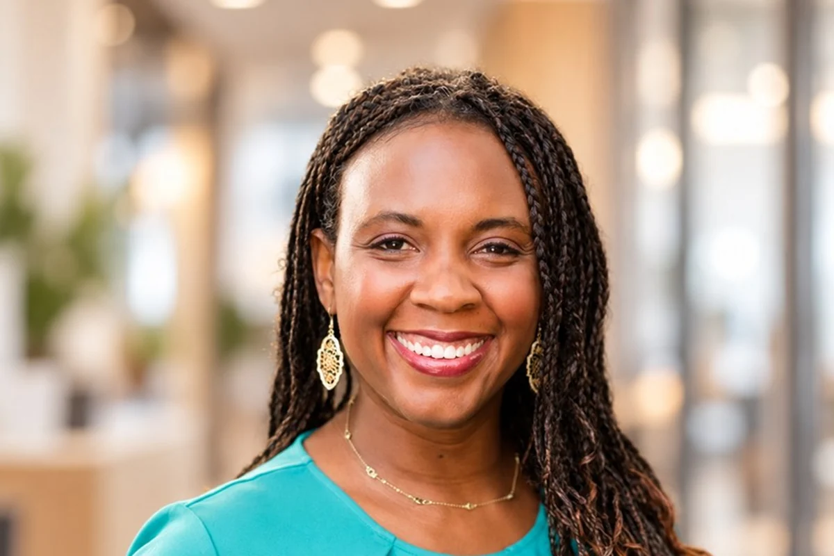 A professional headshot of Dr. Nikel Rogers-Wood, smiling toward the camera.