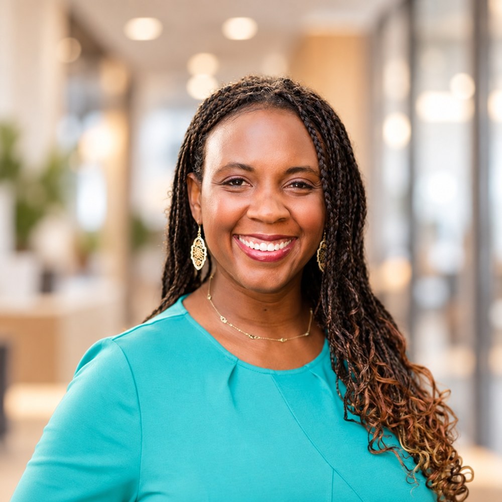 A professional headshot of Dr. Nikel Rogers-Wood, smiling toward the camera.